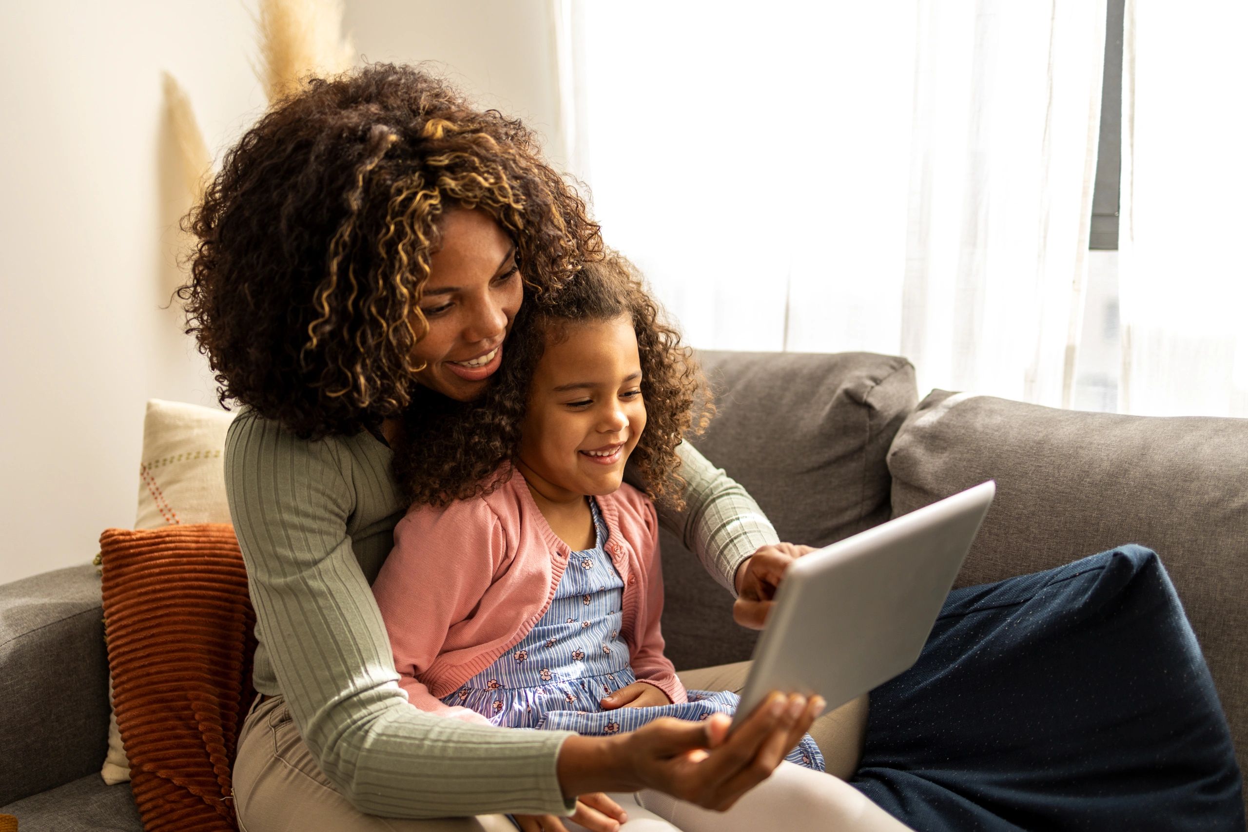 Parent and child using a tablet at home