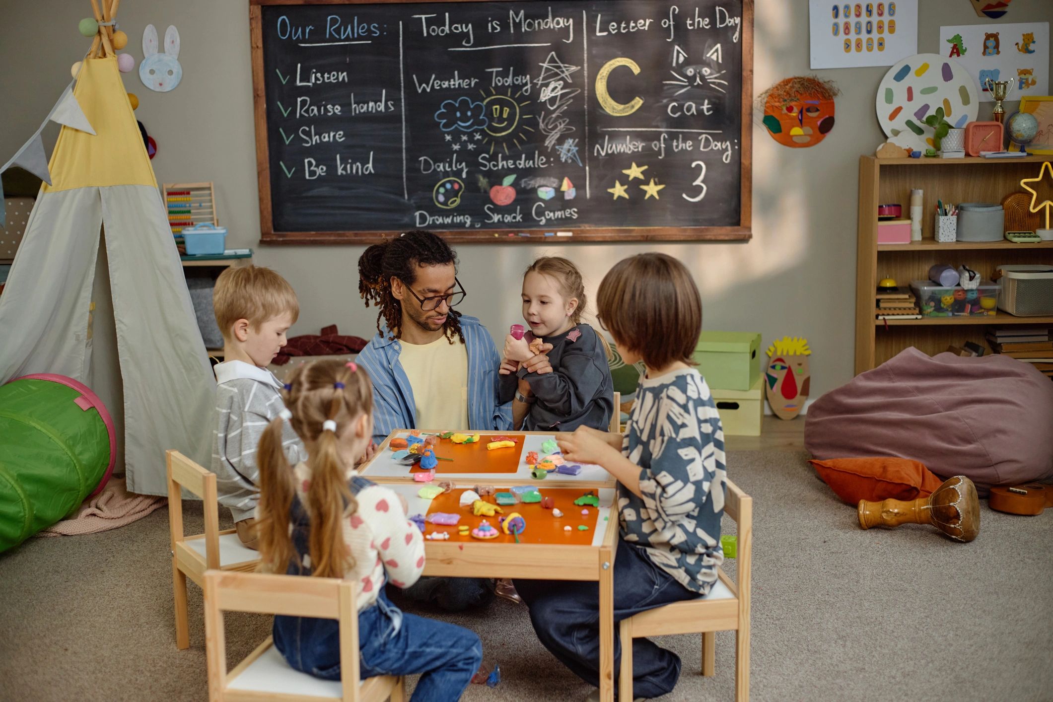 Teacher working with children in a kindergarten classroom